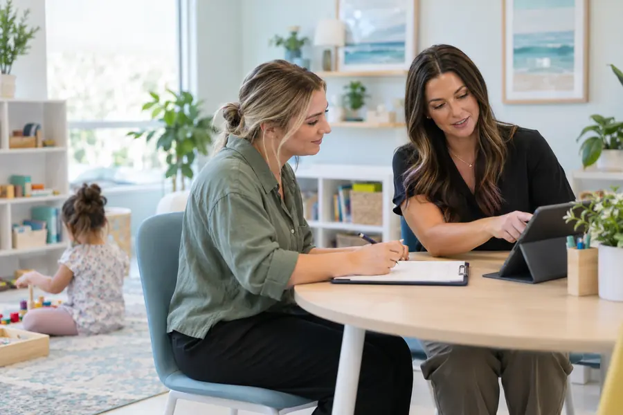 A behavior analyst collaborating with a behavior technician in a bright clinic